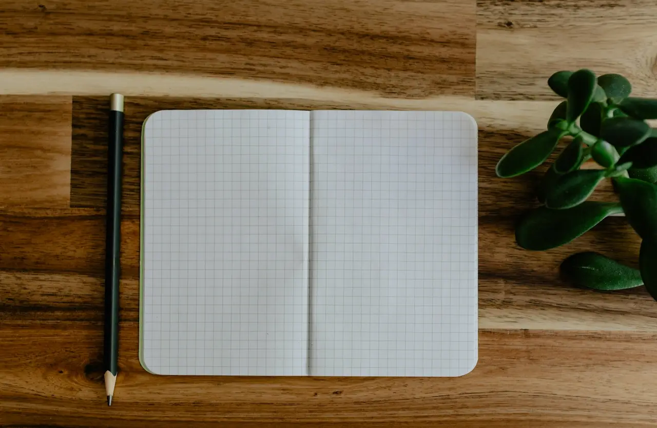 Un carnet et un stylo sur une table en bois