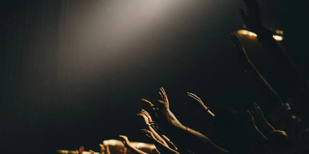 group of people waving their hands