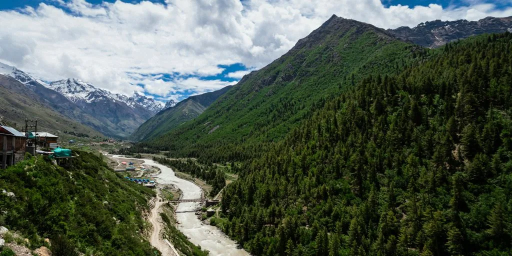 a river running through a lush green valley