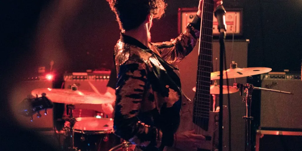 man holding electric guitar